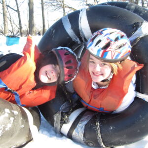 winter campers smiling inside tubes